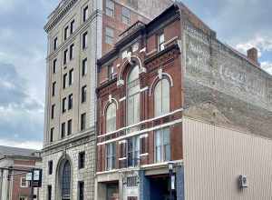 Built in 1883, this Romanesque Revival and Italianate-style building was constructed to serve as a Masonic Temple.  The building features a red brick exterior with roman arched window bays on the third floor, one-over-one double-hung windows, a