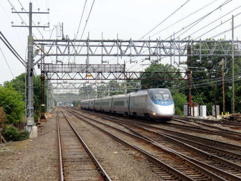 A southbound Acela Express train viewed from the rear of a Grand Central-bound New Haven Line train in July 2019