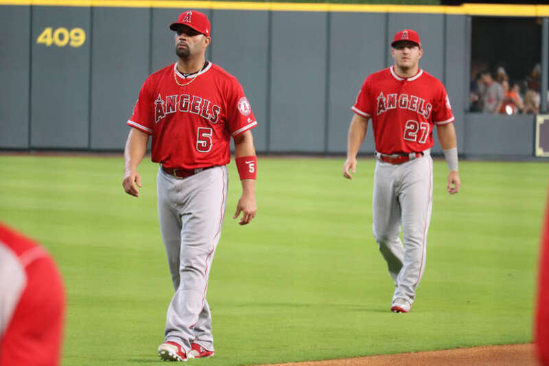 Los Angeles Angels players Albert Pujols (left) and Mike Trout (right) walk down the right field foul line before a game against the Houston Astros at Minute Maid Park in Houston, Texas on April 25, 2018.