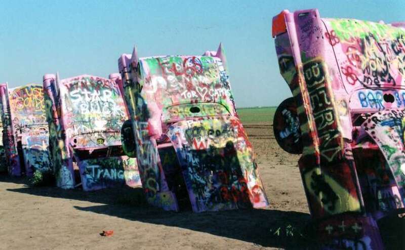 (1 in a multiple picture set)
A closer view of Cadillac Ranch along old Rt. 66 west of Amarillo. While we were they a film crew frm a local station was making a documentary and asked to interview us.  We found magic markers left at the site and added