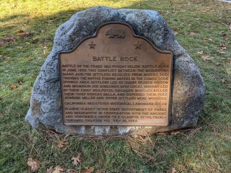 Plaque in Castle Rock State Park commemorating the Battle of the Crags. The plaque reads:
Battle Rock
Battle of the Crags was fought below Battle Rock
in June 1855. This conflict between the Modoc In-
dians and the settlers resulted from miners