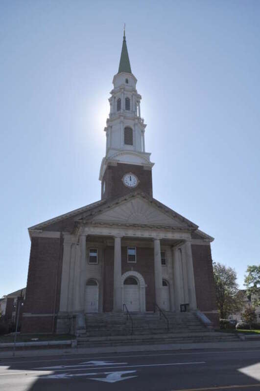 United Congregational Church, Bridgeport, Connecticut.  It is backlit with the sun behind the steeple.