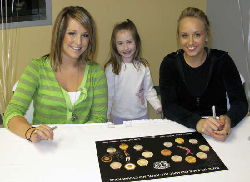 2 All around Olympic Gold artistic gymnastics medalists, Carly Patterson (Athens 2004) and Nastia Liukin (Beijing 2008) posing with a young girl (author's daughter)