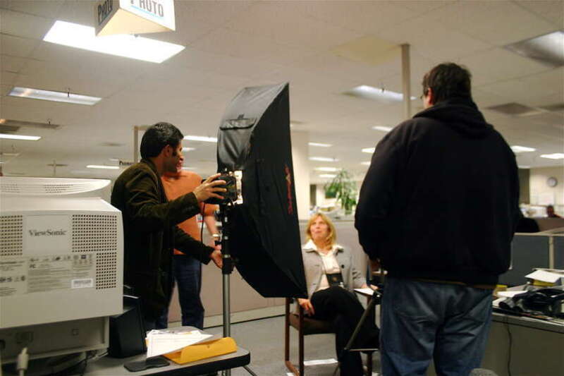 Times photographer Nader Khouri adjusts a lamp and photographer Mark DuFrene stands in the background as producer Karim Amir watches Political Editor Lisa Vorderbrueggen.