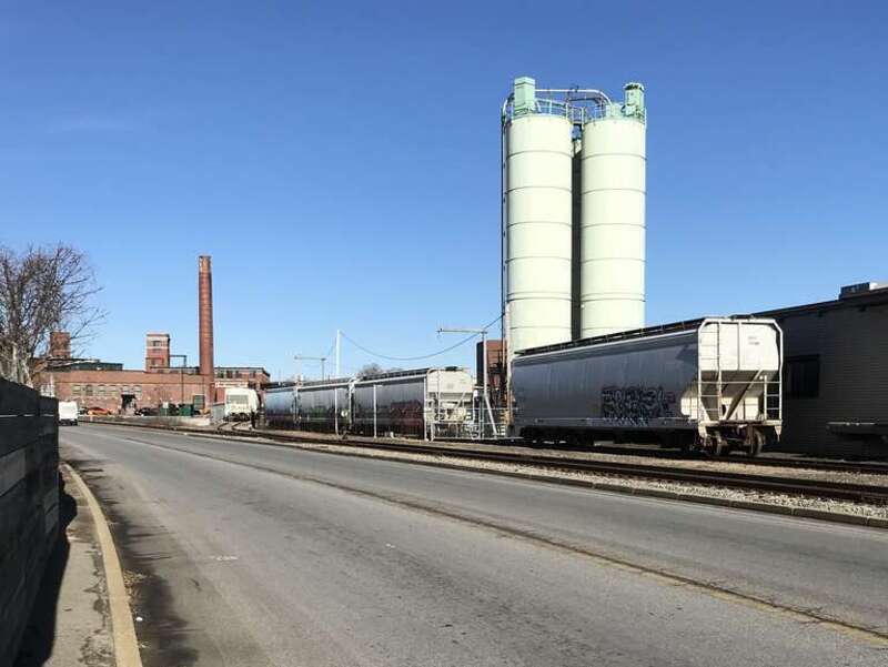 Covered hoppers parked on two sidings for customer Teknor Apex on the East Providence Branch in Pawtucket, Rhode Island.