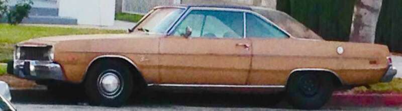 Car randomly parked on a busy street.