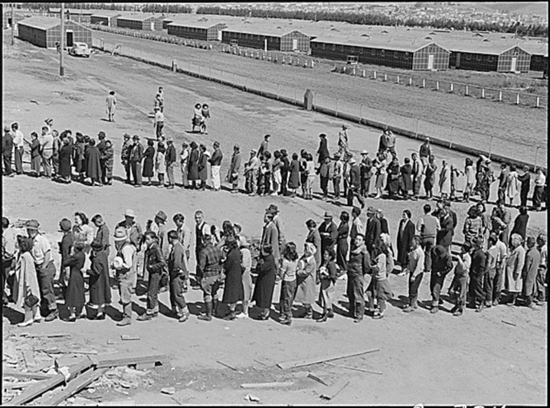 San Bruno, California. This assembly center has been open for two days. Bus-load after bus-load of evacuated persons of Japanese ancestry are arriving on this day after going through the necessary procedures, they are guided to the quarters assigned