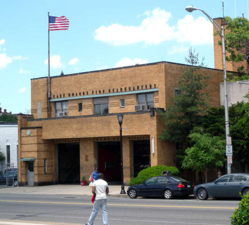 Looking north across Main Street, east of Ashland, at en:East Orange, New Jersey fire headquarters on a mostly sunny midday.