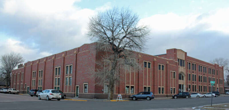 The East Side School, located at 710 East Garfield Street in Laramie, Wyoming. The former school occupies an entire city block. This view is from the corner of 7th and Custer streets. The view of the front of the building on East Garfield Street was