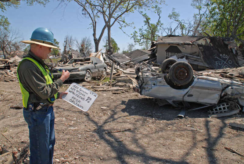 New Orleans, LA, 4-9-06 -- FEMA Debris Specialist for Private Property Debris Removal, Phillip Jones, takes a photograph to record the debris Hurricane Katrina left on this lot in 9th Ward.
FEMA is identifying, marking, and documenting what is on