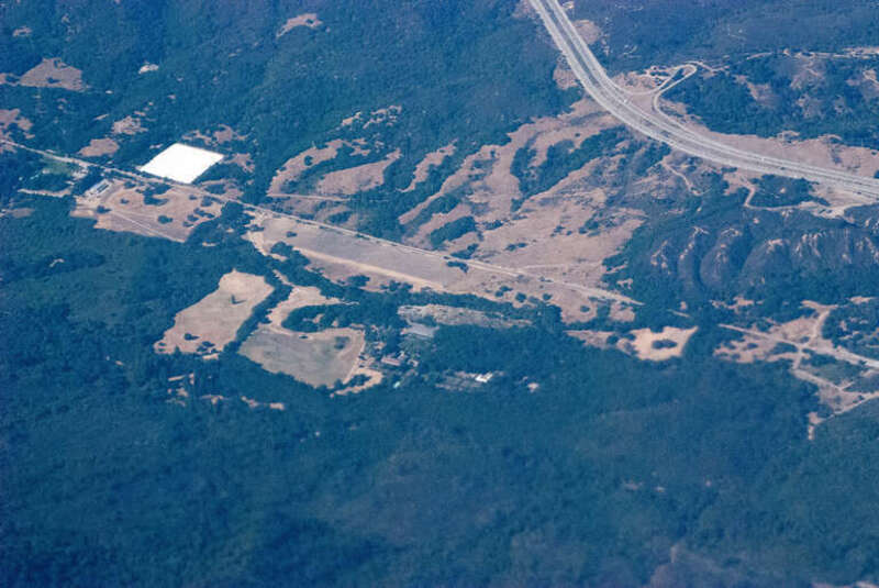 Also a scenic overlook, off northbound 280, the freeway in upper right. The diagonal line running from high on the left to low on the right is Cañada Road. Scene of Sunday recreational bicycle riding. I have no idea what that big, white, roof is