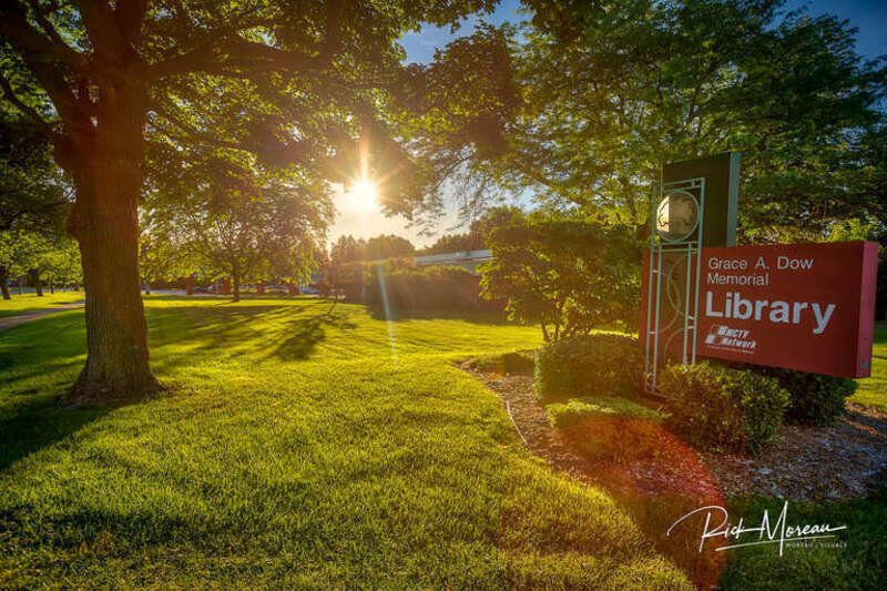 The Summer sun sets over the Grace A Dow Library in Midland MI.