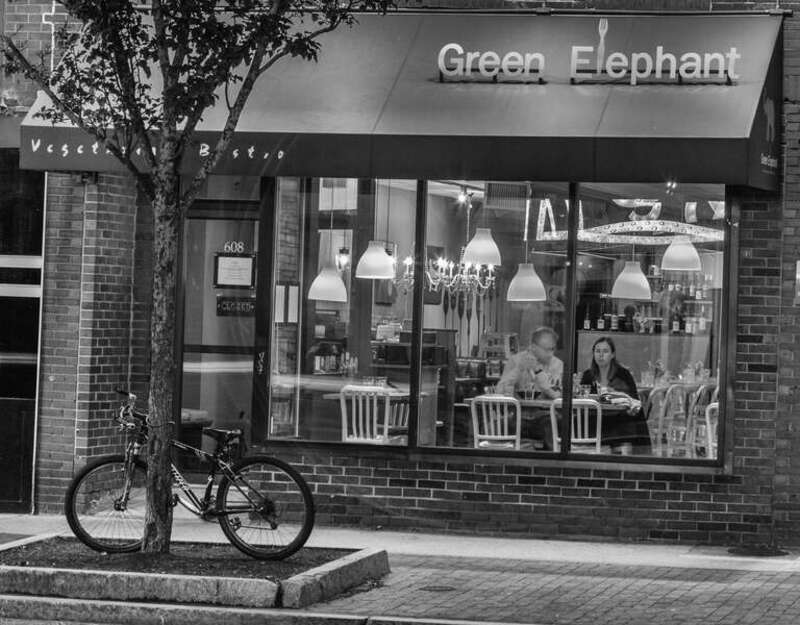 Flickr description

The Green Elephant is an 'Asian Inspired Vegetarian Bistro'. It is also one of the best restaurants that served vegan dishes. I can recommend it. Looks like the last two patrons are enjoying their meal and gazing out at Congress