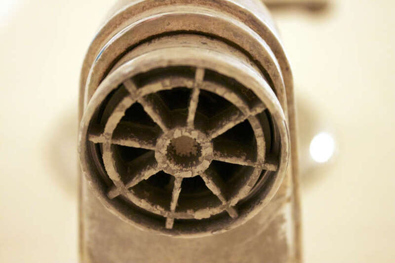 A tub faucet with built-up calcification from hard water in Southern Arizona.