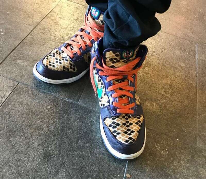 Faux fur, purple leather, green swoosh, orange laces and dragon image on tongue.