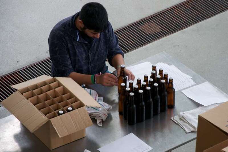 A person labeling experimental beer at the fermentation lab at Oregon State University