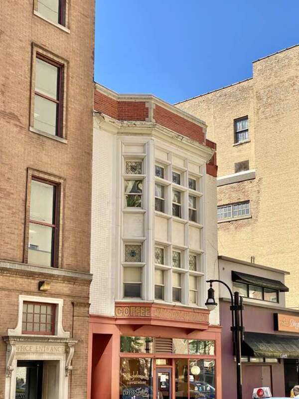 Built in 1905, this Tudor Revival-style building was designed by Claude and Starck for retired attorney F. J. Lamb.  The building is clad in red brick with a large Tudor Revival-style two-story oriel window with one-over-one windows and diamond pane