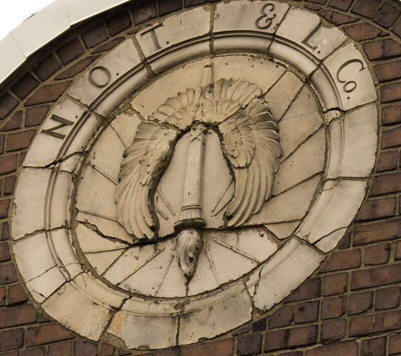 This medallion appears on the Northern Ohio Traction &amp;amp; Light building, 42 N High Street, Akron, Ohio.  It appears the torch has been turned upside down at some point.