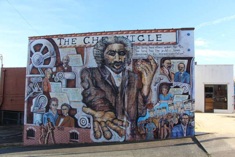 A mural on the side of the Winston-Salem Chronicle building that displays a history of the black press in the United States. This was done by Marianne DiNapoli-Mylet as well as seven students in 1998.