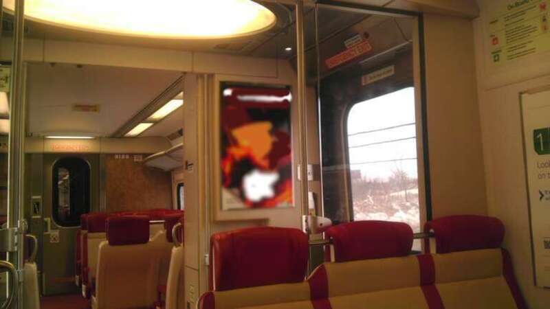 The interior of Metro North Railroad's New Haven Line M8 Car 9128, as it appeared in December 2012. This photo has been modified to make the (presumably copyrighted) advertising illegible.