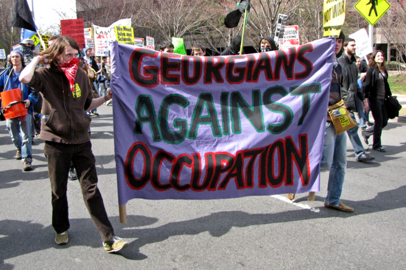 Two people carry a banner reading &quot;Georgians Against Occupation&quot; down South Clark Street in Arlington, Virginia's Crystal City neighborhood.
The March on Crystal City (formally the March on the Pentagon) was a protest against the wars in Iraq and
