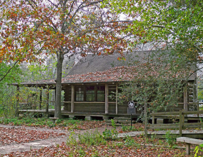 n 1931-32 Edith L. Moore and her husband built this house of pine logs they cut from their land. The stone fireplace and chimney were built of sandstone curbstones salvaged from downtown Houston. Dairy farming and logging provided their livelihood.