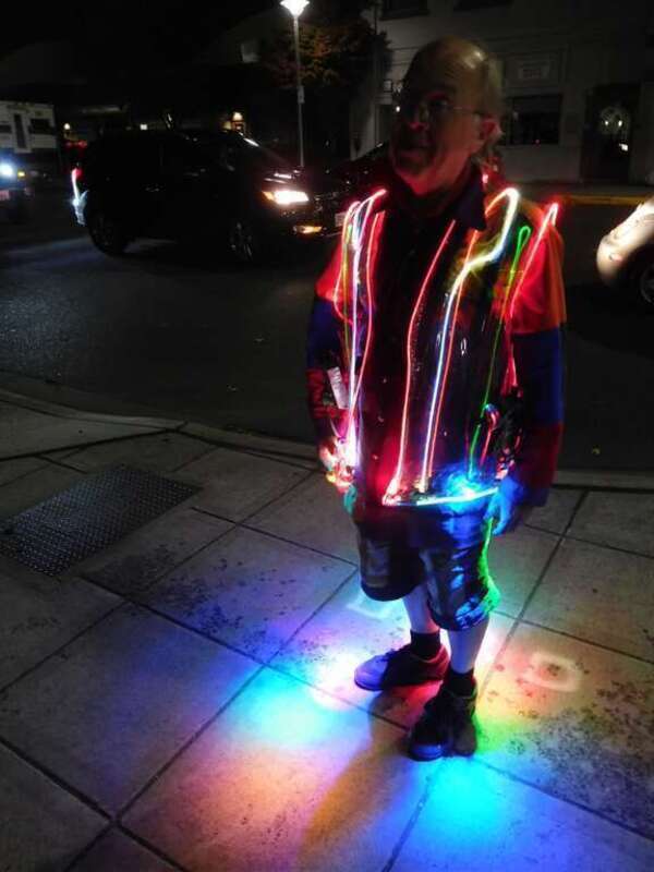 My friend Mark Allyn who recently moved here from Hillboro, Oregon. Worked for Intel and has now &quot;escaped&quot; to a life of artistic retirement. Loves walking around glowing up our city of subdued excitement.  I like the way it lights up the sidewalk. —