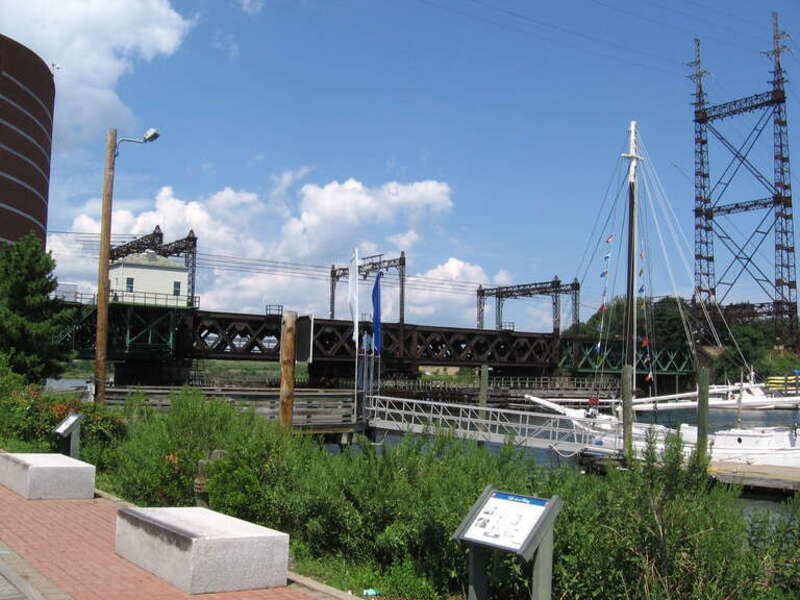 Norwalk River railroad bridge in the South Norwalk section of Norwalk, Connecticut. 
The picture was taken from the South Norwalk side of the river (on the west bank), looking north at the bridge. The edge of the IMAX theater at the Maritime Aquarium