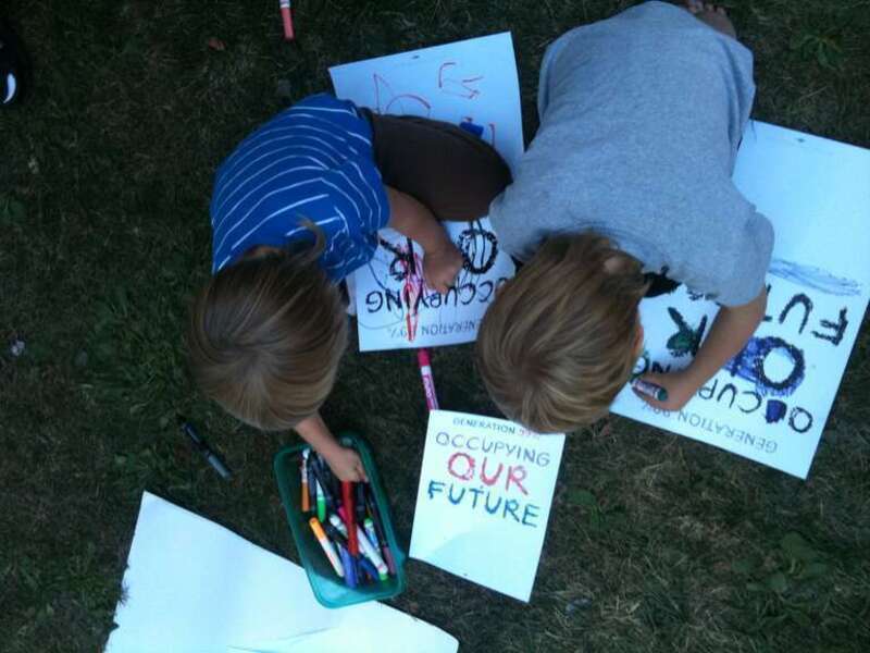 Kids coloring &quot;Operation 99% Occupying Our Future&quot; signs. Oakland Public Library kids gathering.