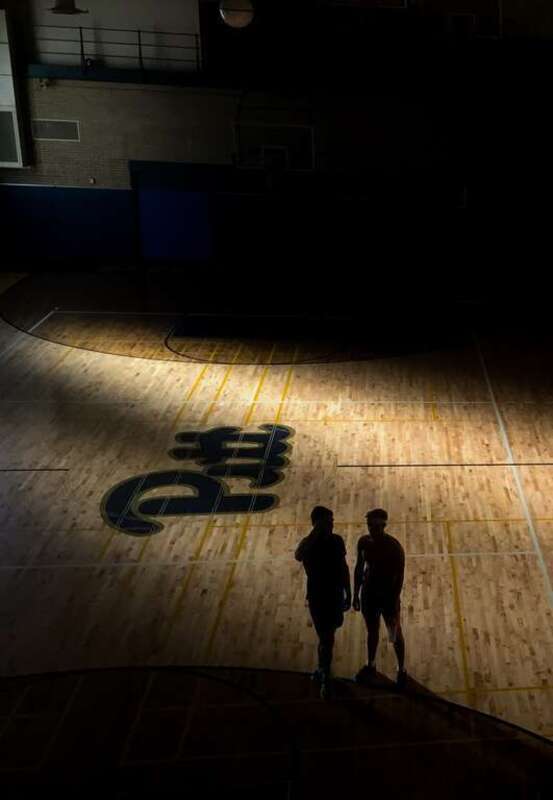 Two men on the basketball court at Bellefield Hall