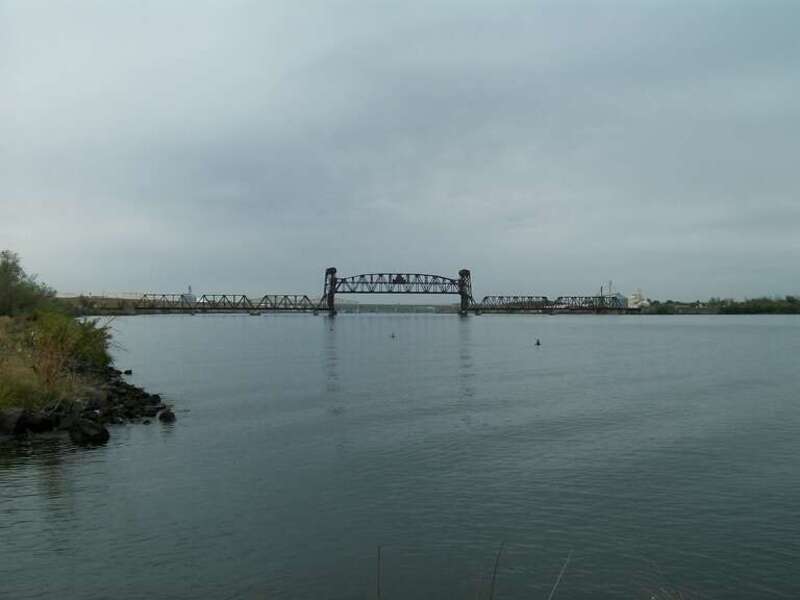 A railroad lift bridge over the Snake River. The Vaughn Hubbard bridge is visible in the background.