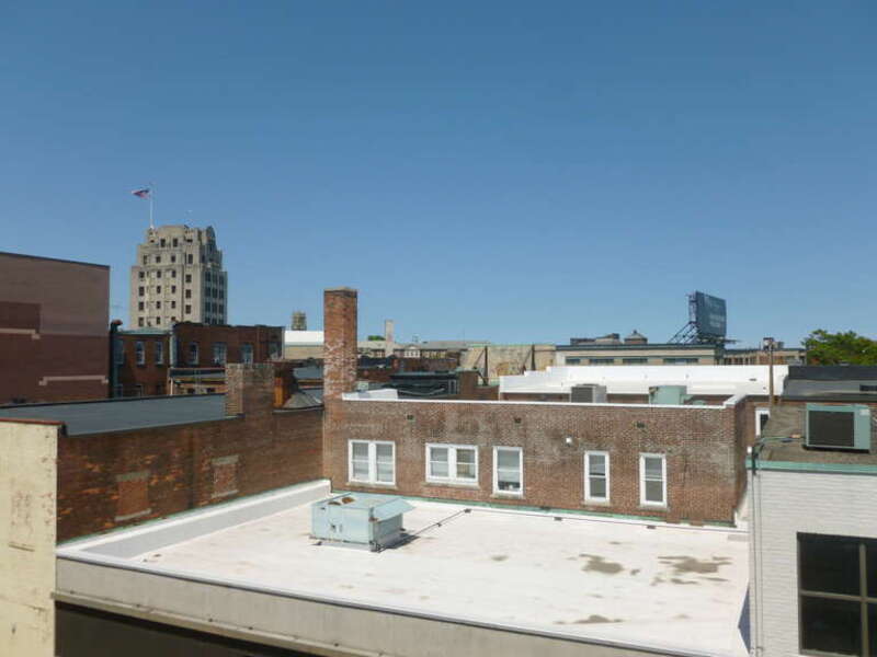 Rooftops in the center of Quincy, Massachusetts, viewed from Ross Garage.  The high rooftop at left is1400 Hancock Street -- a Bank of America building.