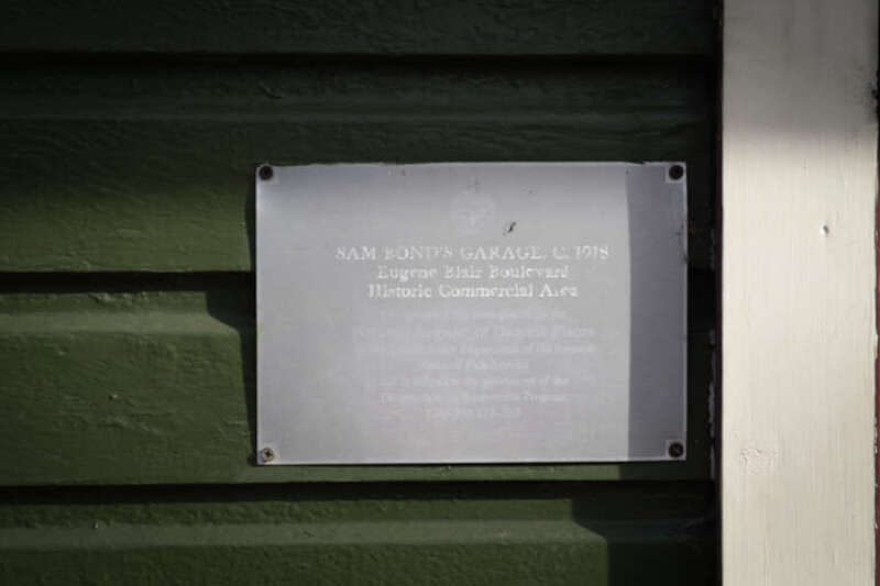 The NRHP site plaque on Sam Bond's Garage, part of the Eugene Blair Boulevard Historic Commercial Area.