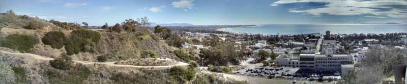 This view shows the Ventura Botanical Garden trail viewpoint, the back of City hall with downtown scene and Anacapa Island across the Santa Barbara Channel. The Santa Monica Mountains can be seen beyond the Oxnard Plain and shoreline also.