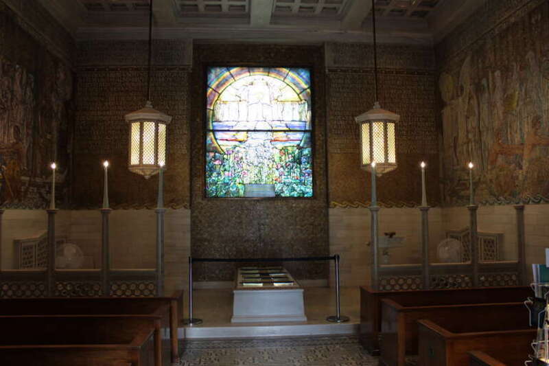 Interior of the Wade Memorial Chapel, with the stained glass window &quot; The Flight of Souls &quot; centerpiece.