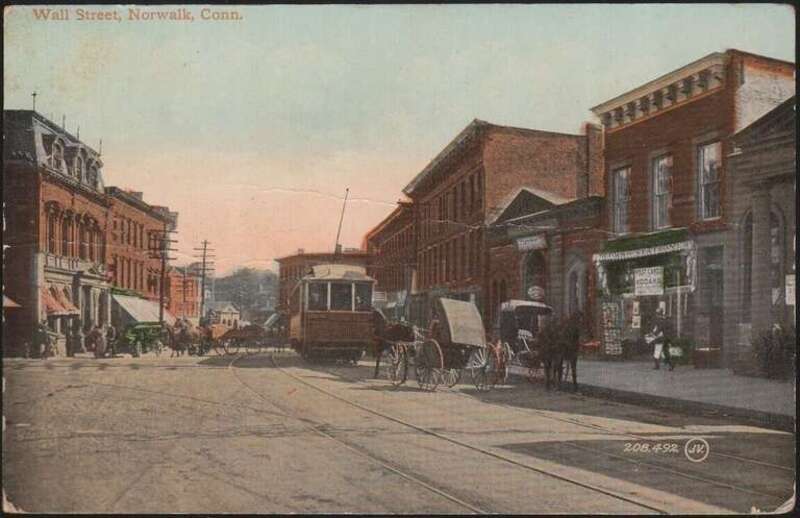 Divided back postcard of Wall Street in downtown Norwalk, looking east near River Street, postmarked in 1913. The low building to the right of the streetcar is Wall Street (Norwalk) station.