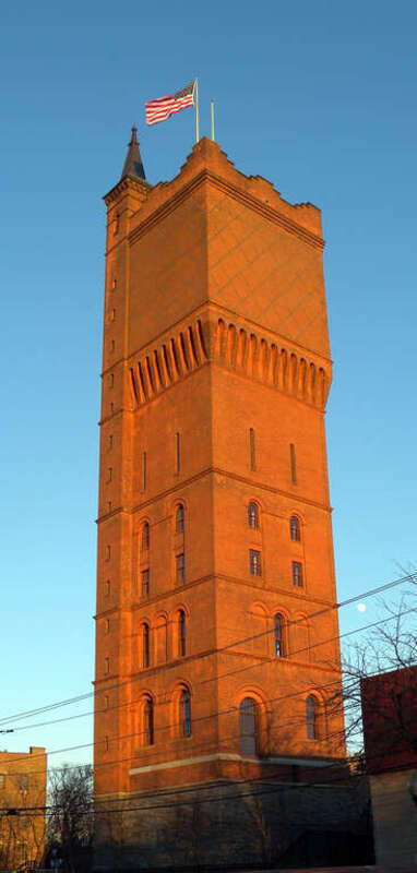 Looking east across Park Av at red tower of Hackensack Water Company Complex, now Water Tower Park, on a sunny late afternoon.