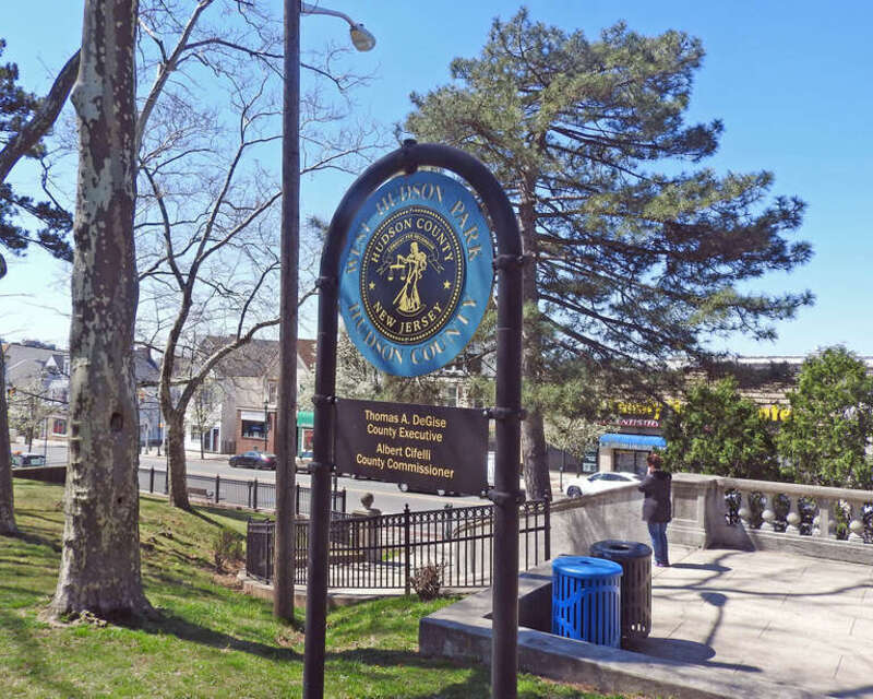 Looking west at park sign on a sunny midday