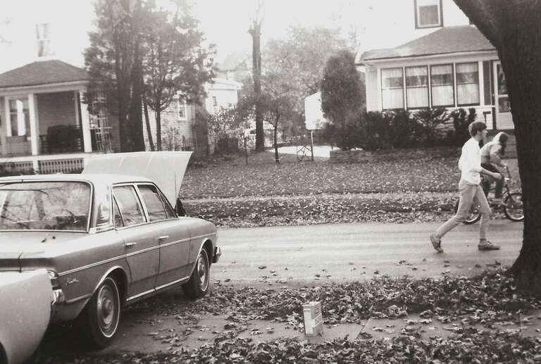 Autumn Saturday on Gunson Street, Jim Rozek in the street.  Laura's car (a 1964 Rambler Ambassador sedan manufactured by American Motors Corporation - AMC) getting some work done.  We didn't give Laura much respect, but much of it was due to her