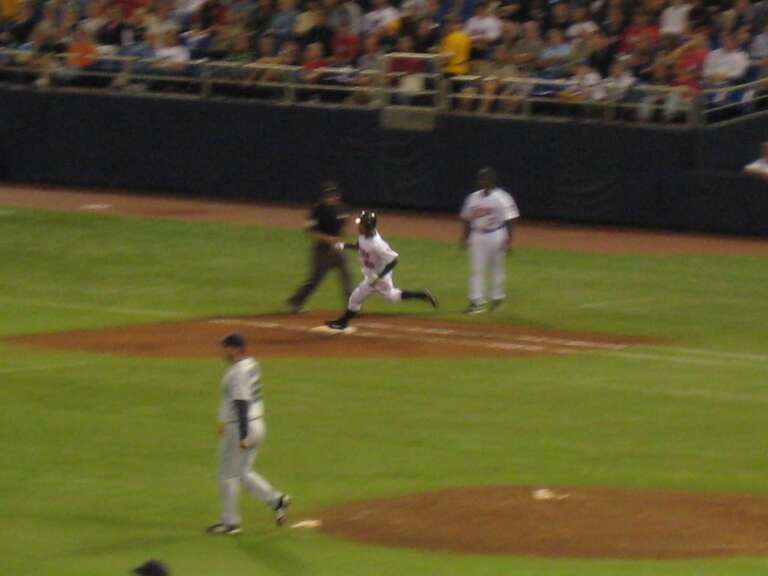 Alexi Casilla rounds first base.
