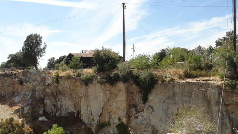 According to the guides at Rocklin History Museum across the street, the masts seen here were salvaged from ships abandoned in San Francisco during the gold rush. They were used as cranes (with additional, diagonal beams) to move heavy pieces of