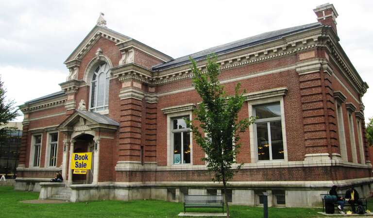 The Fletcher Free Library at 253 College Street at the corner of S. Winooski Avenue in Burlington, Vermont was established in 1873 but outgrew its initial building on Church Street by 1901. A new building was constructed in 1901-04 with funds