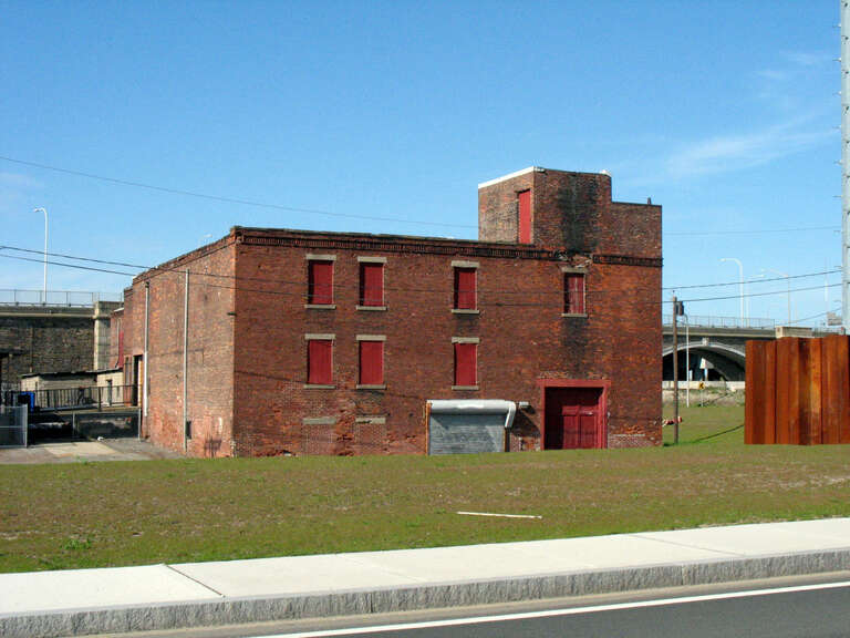 A brick industrial building at India Point in Providence, Rhode Island. The building was demolished between 2011 and 2014. As of 2022, the adjacent building at 271 Tockwotton St has been adaptively reused as a Narragansett Brewery location.