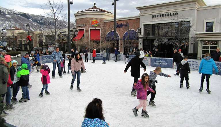 People ice skating at Station Park in Farmington, Utah.