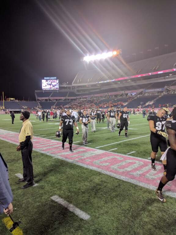 UCF players and staff leaving the field after the loss