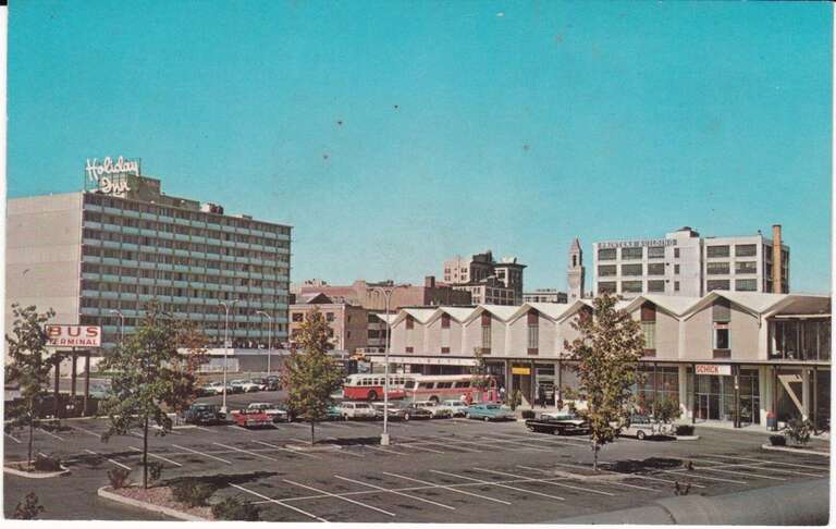 Mid-century postcard of Seven Hills Plaza bus station and a Holiday Inn. The plaza later became Madison Plaza, and the hotel Madison Tower.