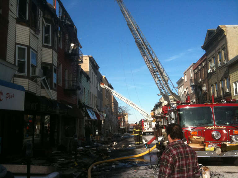 Firefighters from North Hudson Regional Fire and Rescue deal with the aftermath of a fire on Bergenline Avenue between 21st and 22nd Streets in Union City, New Jersey on January 20, 2012. The fire, which started around 9pm on January 18, was not