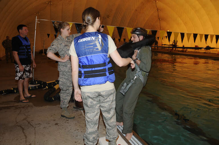 Specialists with the 188th Operations Group’s Life Support Element administer water survival training to pilots with the 184th Fighter Squadron of the 188th Fighter Wing at Creekmore Park in Fort Smith, Ark., March 4, 2012. The training is required