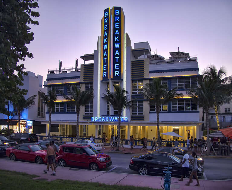 The just-restored Breakwater on Ocean Drive in South Beach is a Streamline Moderne [horizontal emphasis and sleek] building with the largest porch on Ocean Drive.
On Google Earth:

Breakwater Hotel  25°46'47.81&quot;N, 80° 7'51.21&quot;W