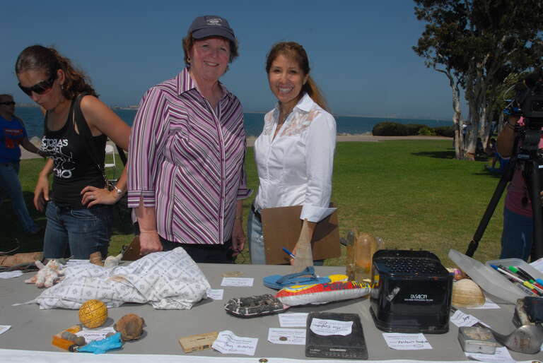 Chula Vista Mayor Cheryl Cox and Port Commissioner Ann Moore review the entries for the "Most Unusual Trash" contest at the Operation Clean Sweep barbecue. (Photos by Dale Frost/Port of San Diego.)